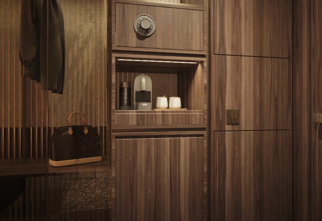 Armario de madera con cafetera y tazas en área de minibar